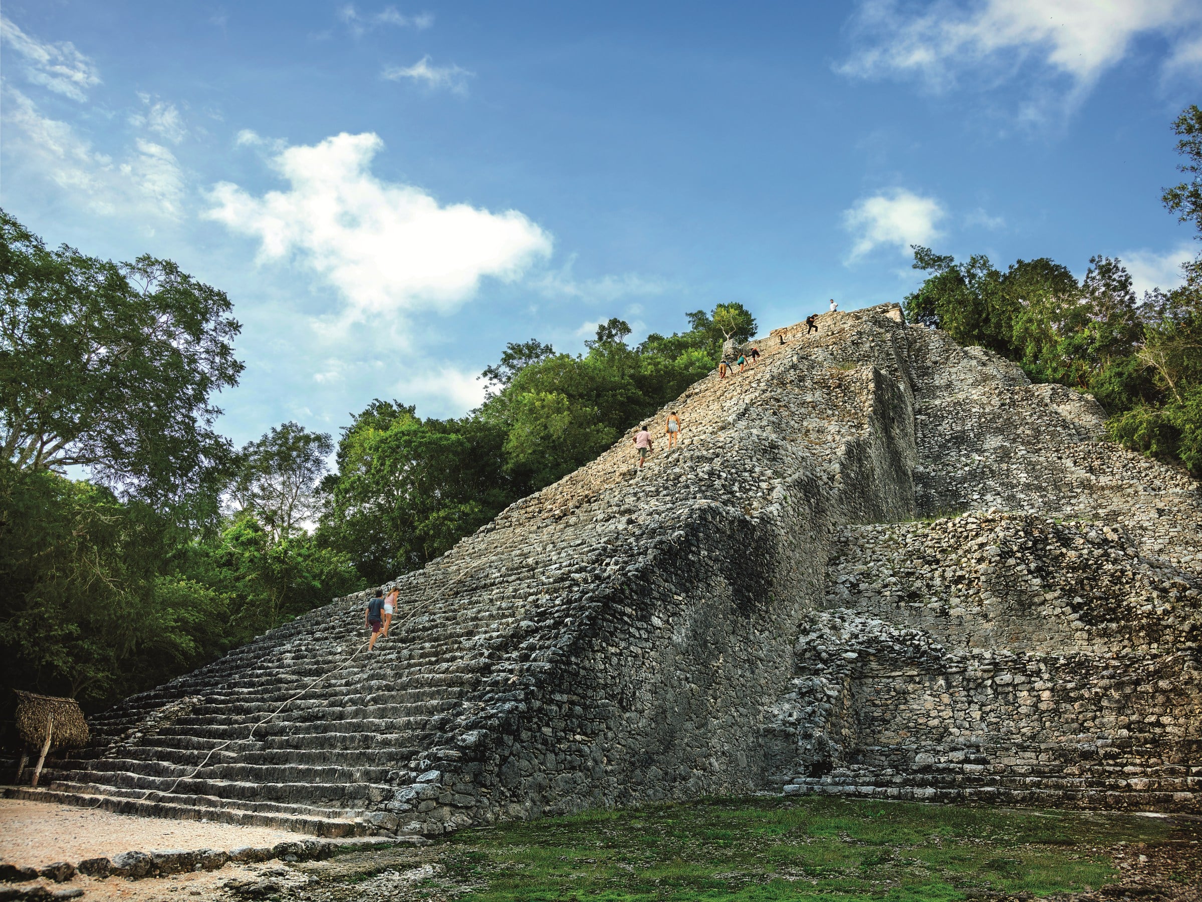 image of two people walking up ruins in Western Caribbean