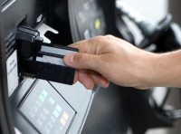 image of person using their card at a gas pump