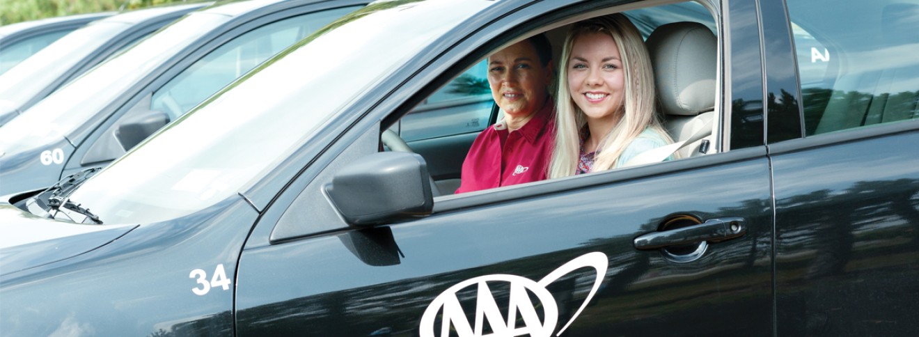 Driving student sitting in car with training instructor in passenger side